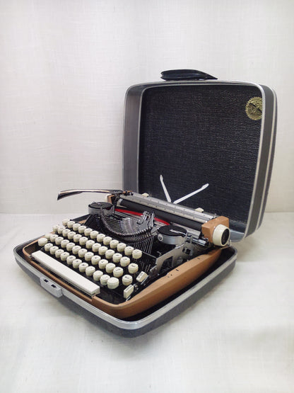 Vintage Smith Corona typewriter in a carrying case on a white background